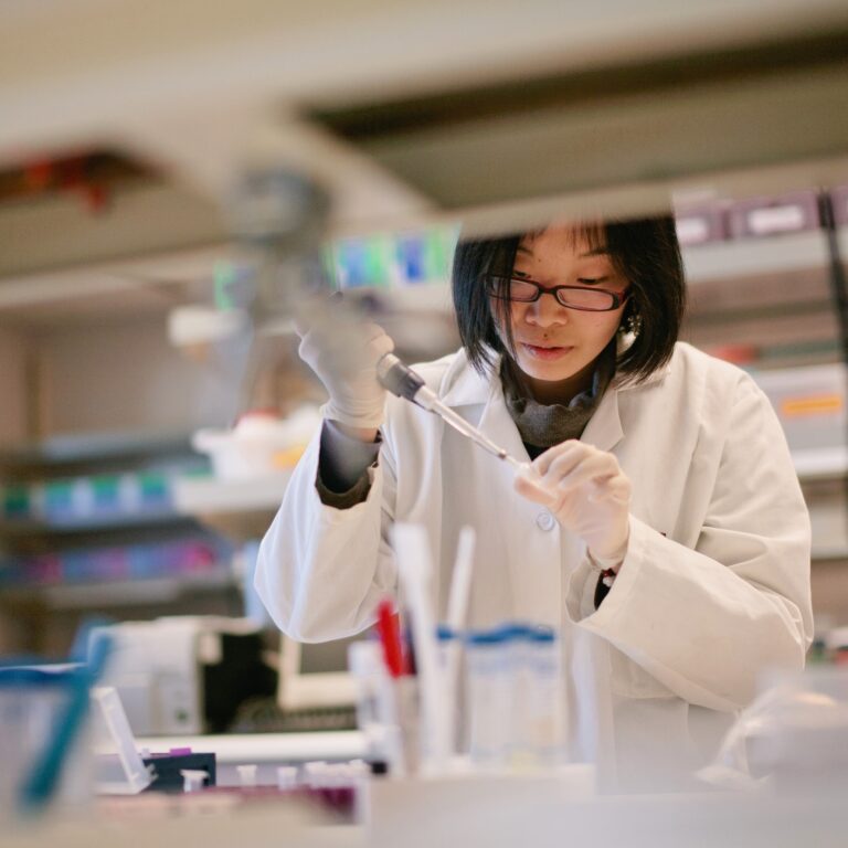 A scientist carefully conducts her experiment in a research laboratory