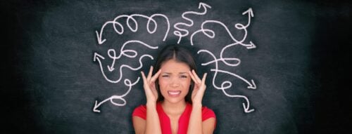 COVID Brain Fog a ‘True Neurological Condition’ Confused woman confusion illustrated on blackboard with chalk drawing of arrows going everywhere around head showing indecision. Indecisive stressed Asian girl with headache panoramic banner.