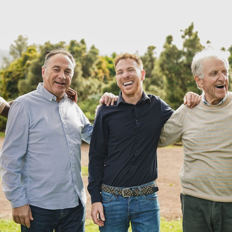 Multi generational men having fun together at city park - Multiracial male friends enjoy day outdoor
