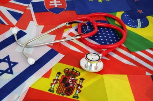 15 Most Advanced Countries in Medicine Medical tourism and medicine in different countries concept. Red stethoscope on national flags background.