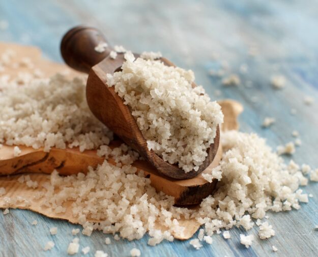 Celtic Grey Sea Salt with a spoon on a blue wooden table