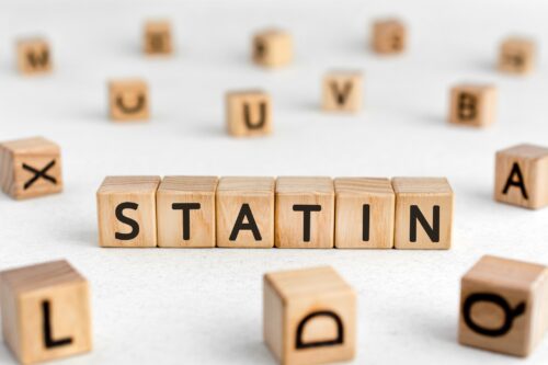 Statins and Causal Risks Statin - words from wooden blocks with letters, cholesterol level reduces drugs statin concept, white background