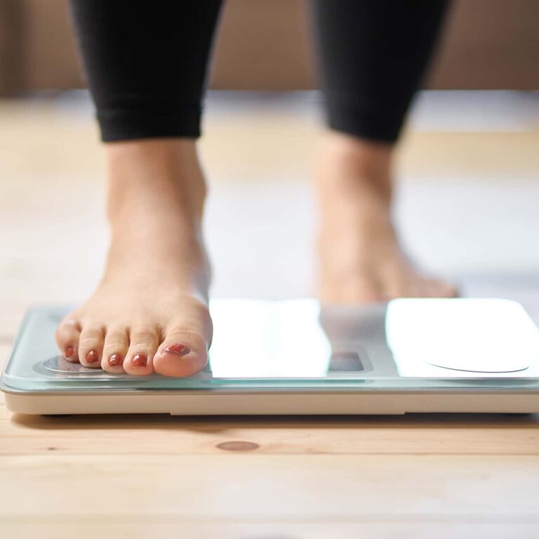 Feet of an Asian woman on a weight scale