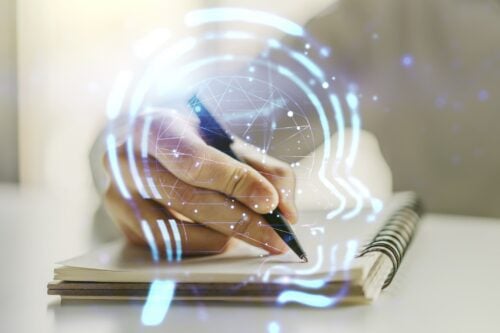 Creative artificial Intelligence concept with human head sketch and man hand writing in diary on background. Double exposure